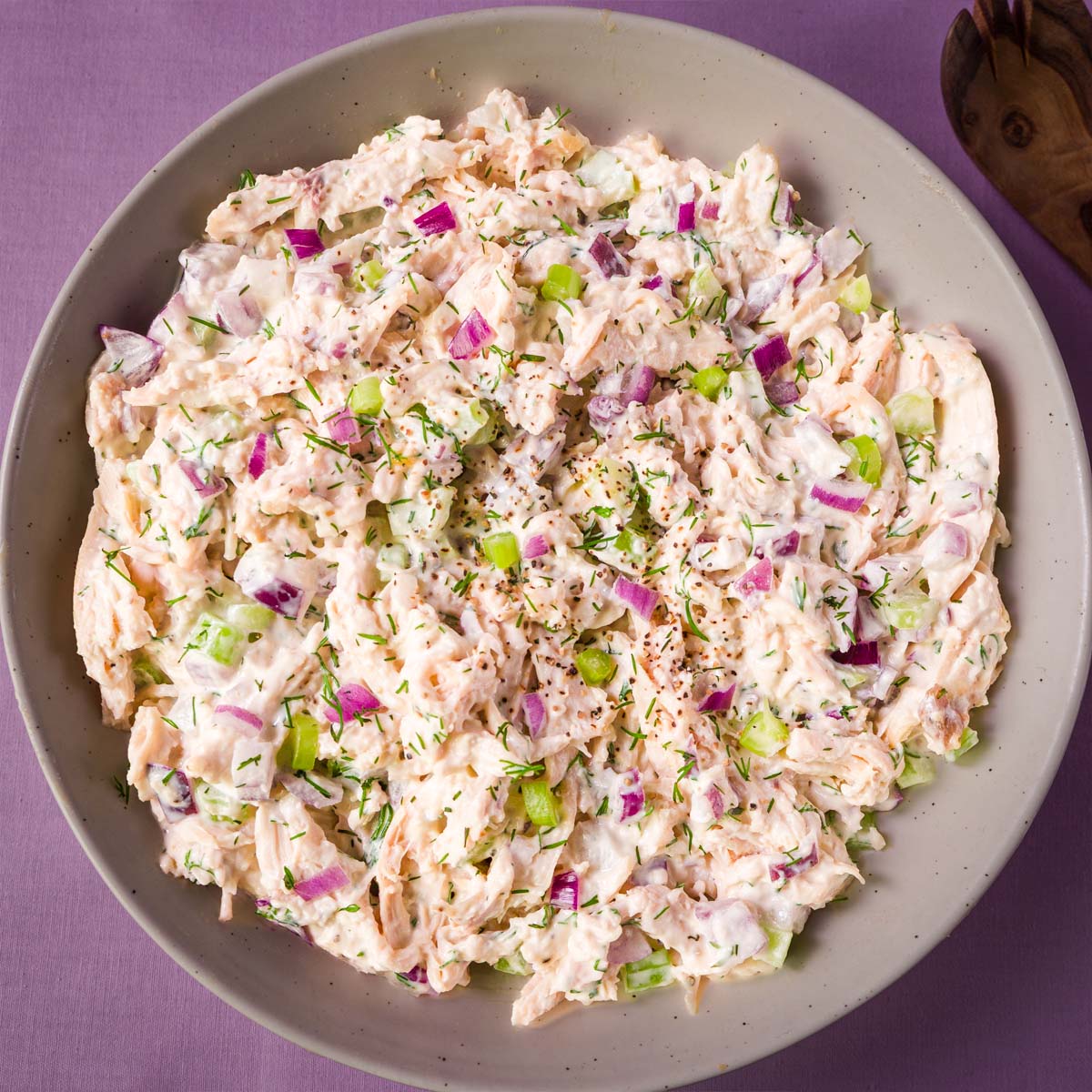 Creamy rotisserie chicken salad with celery, red onion, and fresh dill in a bowl. 