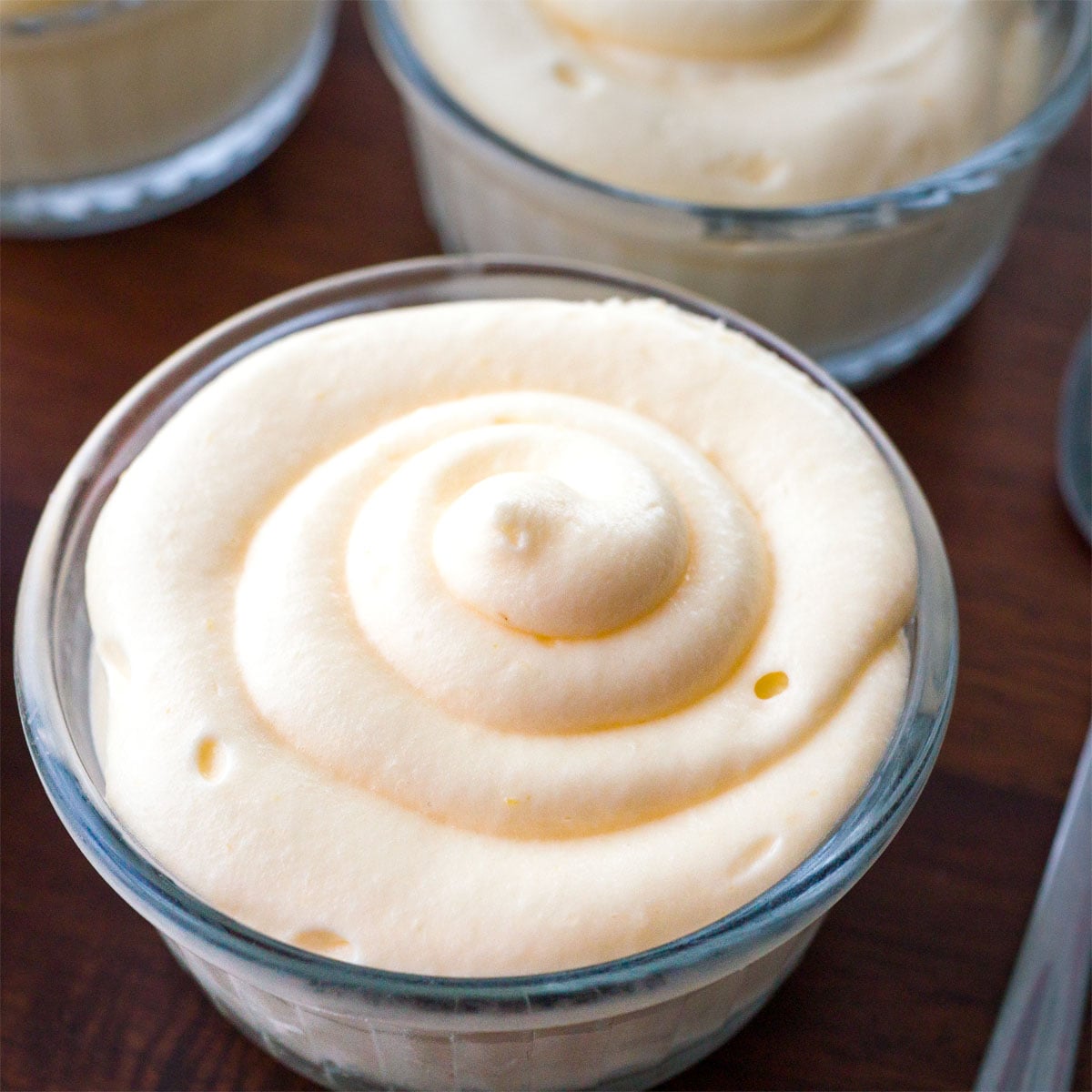 Lemon curd mousse in a glass with a smooth swirled top, ready to serve chilled 