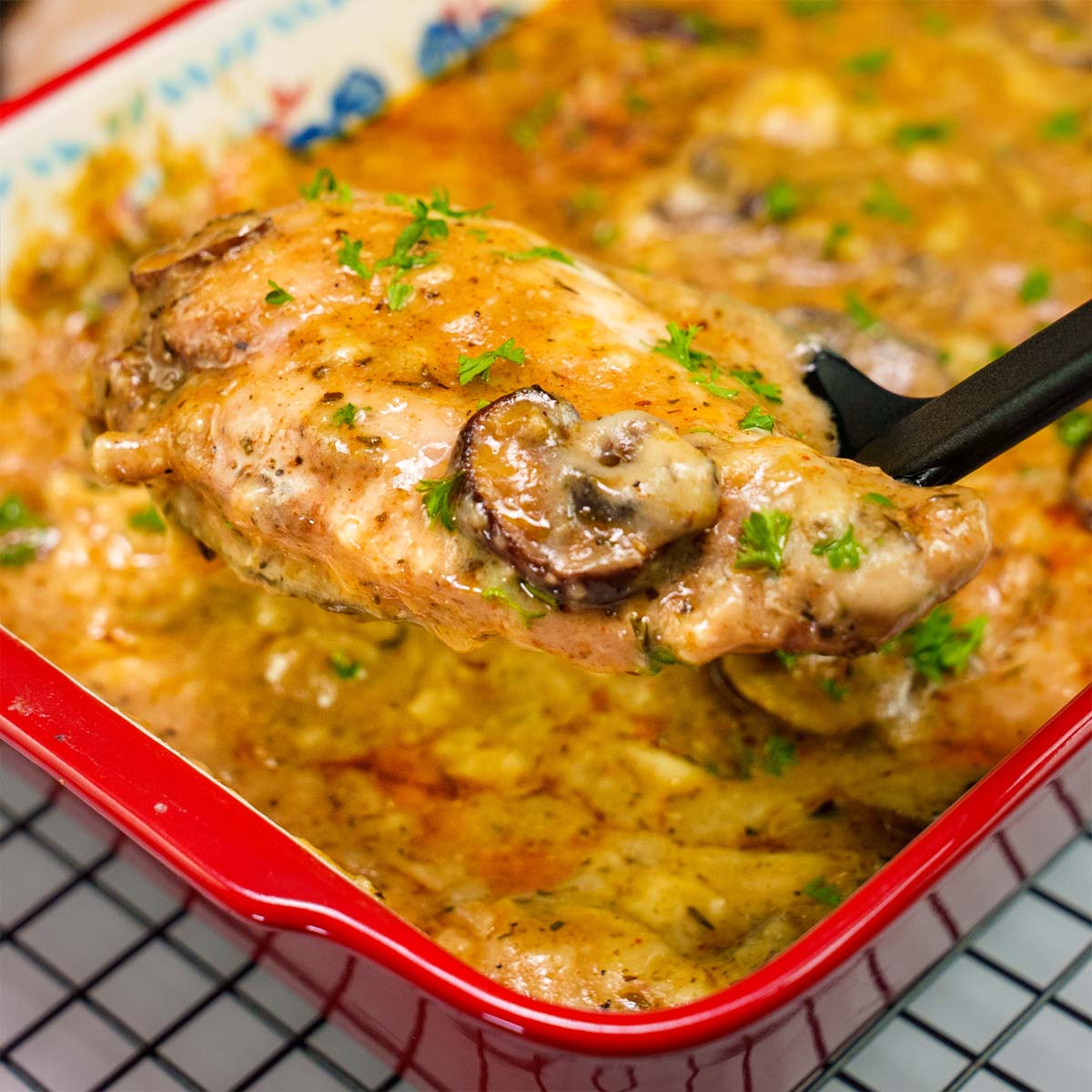 Baked chicken with cream of chicken soup and mushrooms in a red casserole dish