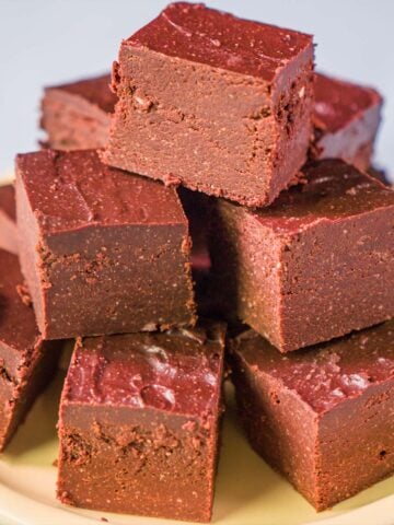 Cottage cheese fudge squares on a plate, smooth no-bake chocolate fudge made with 2 ingredients and high protein cottage cheese.