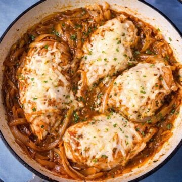 French onion chicken skillet with melted Gruyère cheese and caramelized onions in a pan