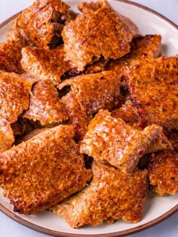 Viral doner kebab meat slices on a plate, browned and crispy at the edges
