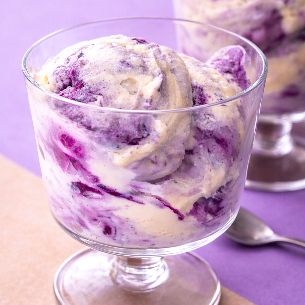 No-Churn Blueberry Ice Cream in a Glass Dessert Cup with Creamy Vanilla Base and Blueberry Compote Swirls