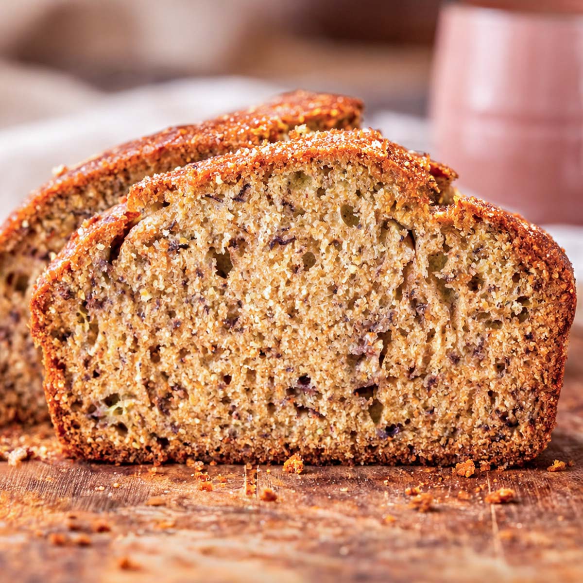 easy moist banana bread sliced loaf on wooden surface showing soft crumb and golden crust