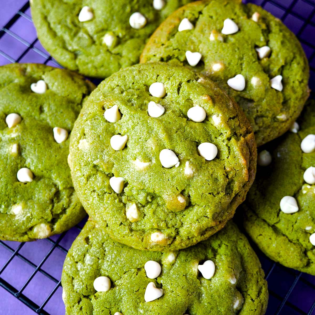Matcha white chocolate chip cookies with vibrant green color and soft chewy texture topped with white chocolate chips