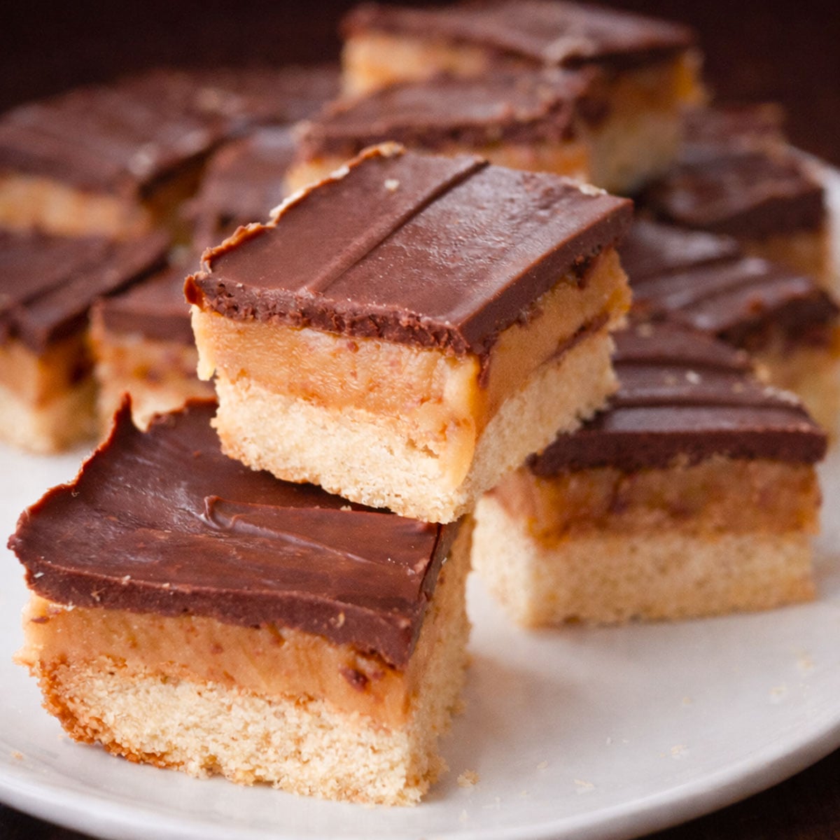 Millionaire shortbread recipe with buttery shortbread base, rich caramel filling, and smooth chocolate topping cut into squares