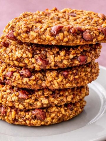 3 Ingredient Oatmeal Cookies No Flour Eggs Sugar Dairy Butter or Oil stacked on a white plate showing chewy oat texture and chocolate chips