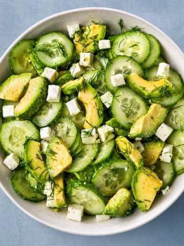 Cucumber avocado feta salad with fresh dill in a bowl, light and refreshing Mediterranean-style salad