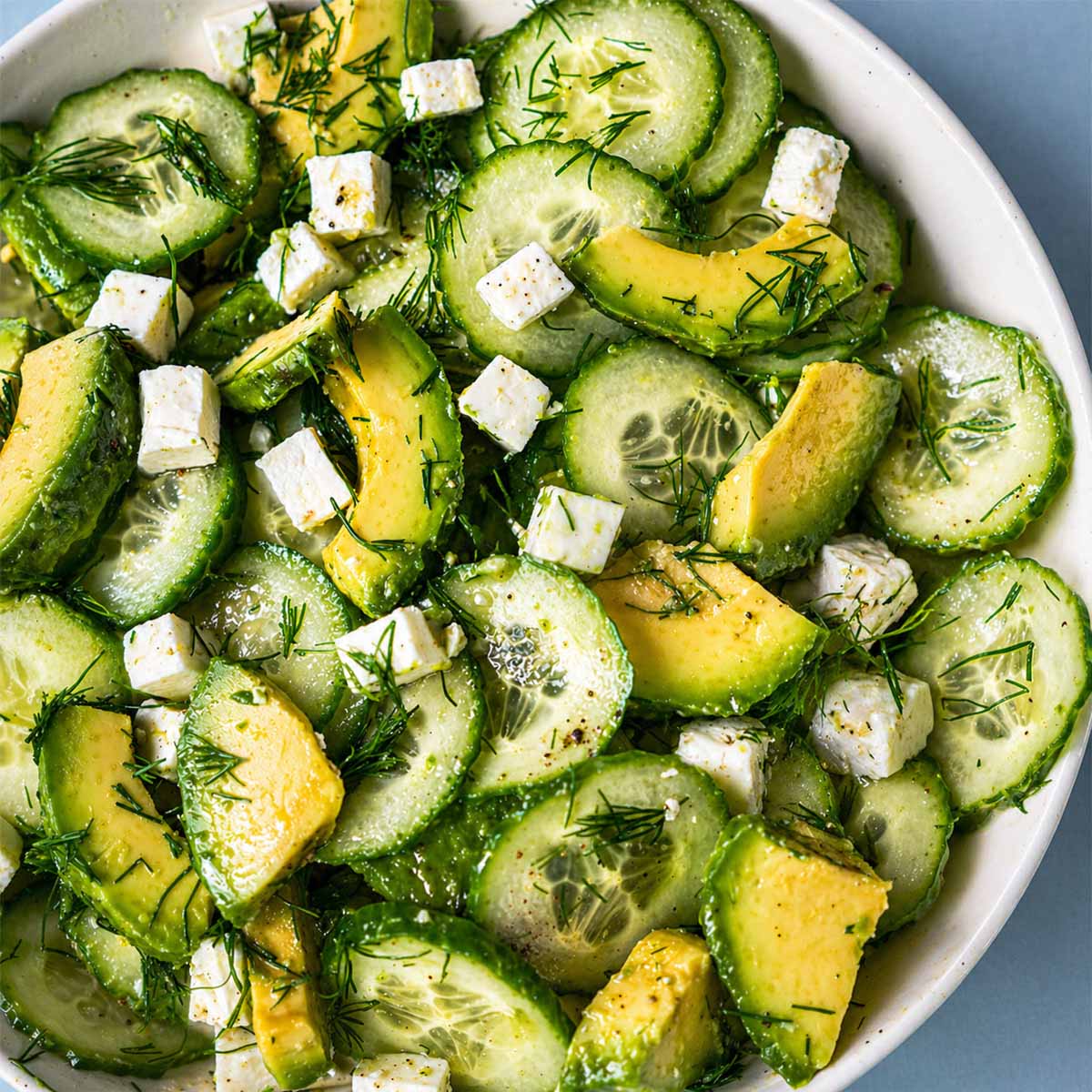 Close up Cucumber avocado feta salad with fresh dill in a bowl, light and refreshing Mediterranean-style salad