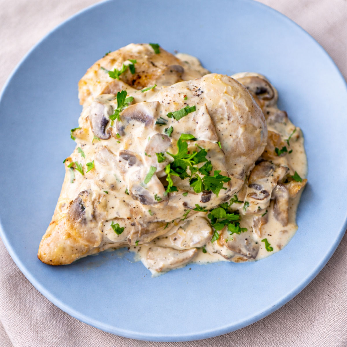 Easy Chicken and Mushrooms Skillet with tender chicken breast topped with creamy mushroom sauce and fresh parsley