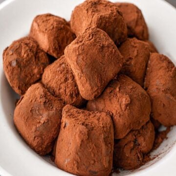 Homemade Chocolate Candy with Cocoa Powder coated in rich cocoa, served in a white bowl with a soft, fudgy texture