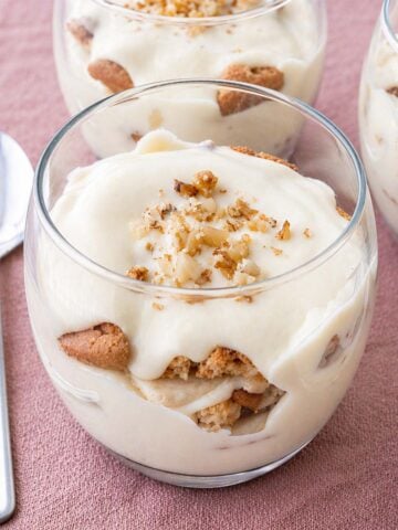 magnolia bakery banana pudding in glass dessert cup with creamy vanilla pudding, banana slices, and cookie layers