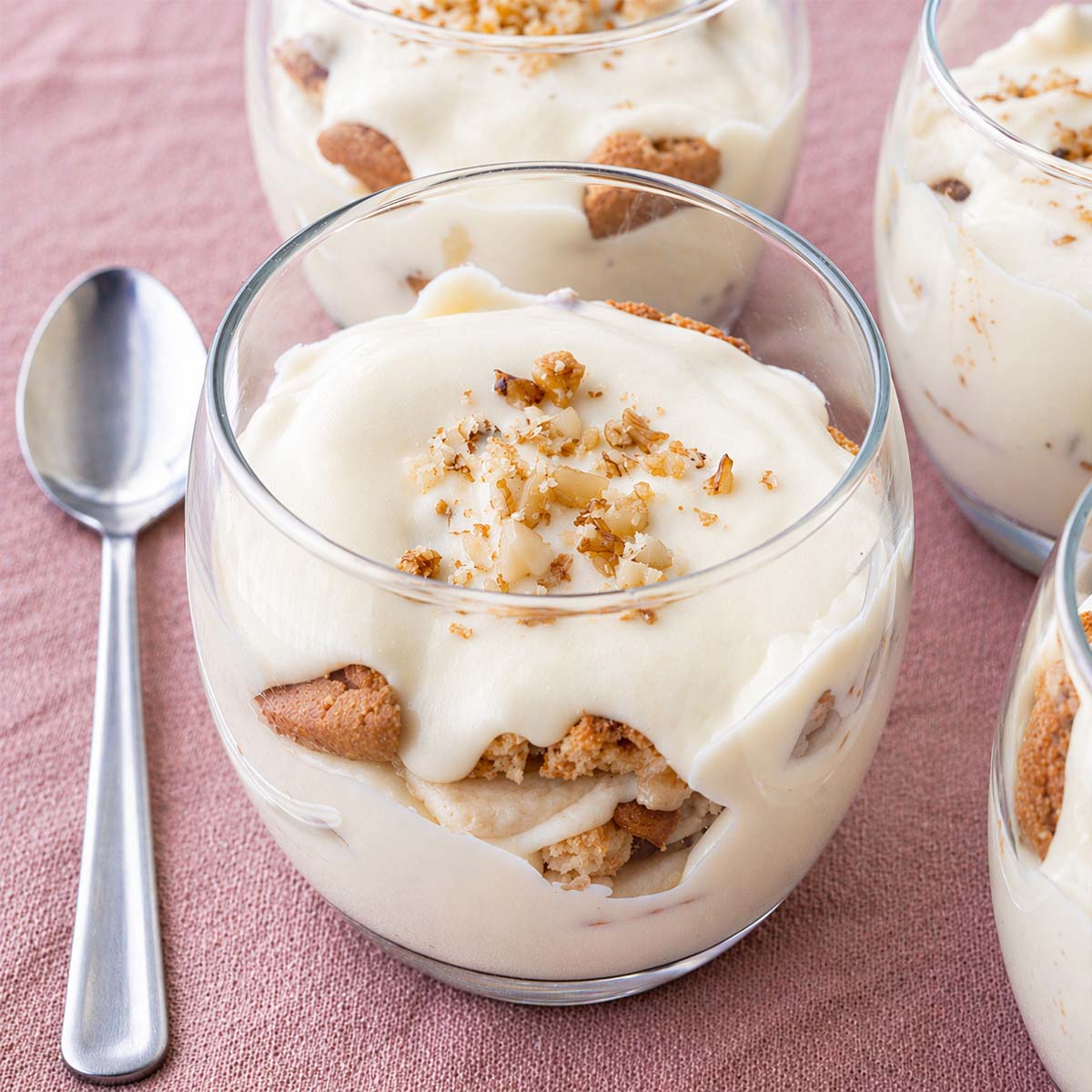 magnolia bakery banana pudding in glass dessert cup with creamy vanilla pudding, banana slices, and cookie layers