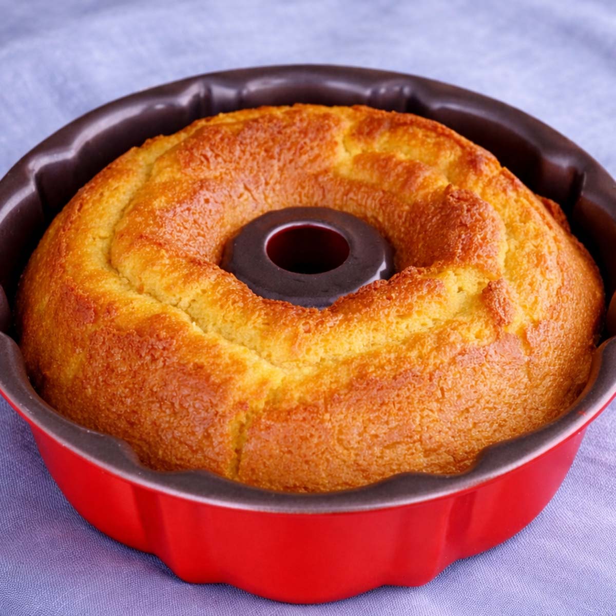orange juice cake baked in a bundt pan with golden crust and soft citrus sponge texture