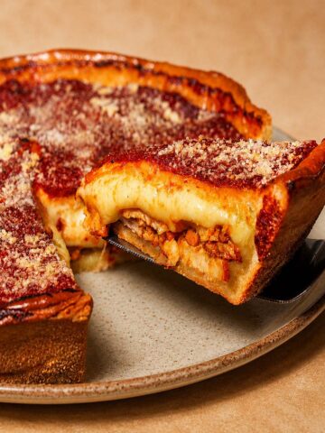 Chicago Style Deep Dish Pizza with thick golden crust, melted cheese, and a slice lifted on a spatula