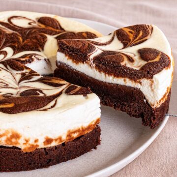 Easy Fudgy Cream Cheese Brownies with swirled cheesecake layer and rich brownie base on a plate