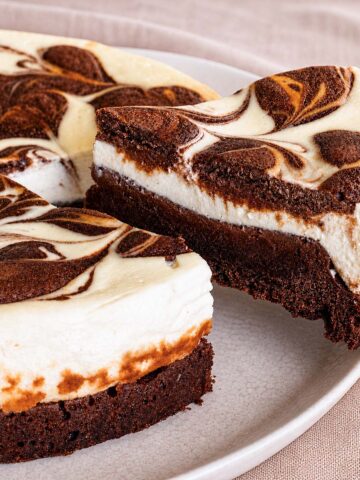 Easy Fudgy Cream Cheese Brownies with swirled cheesecake layer and rich brownie base on a plate