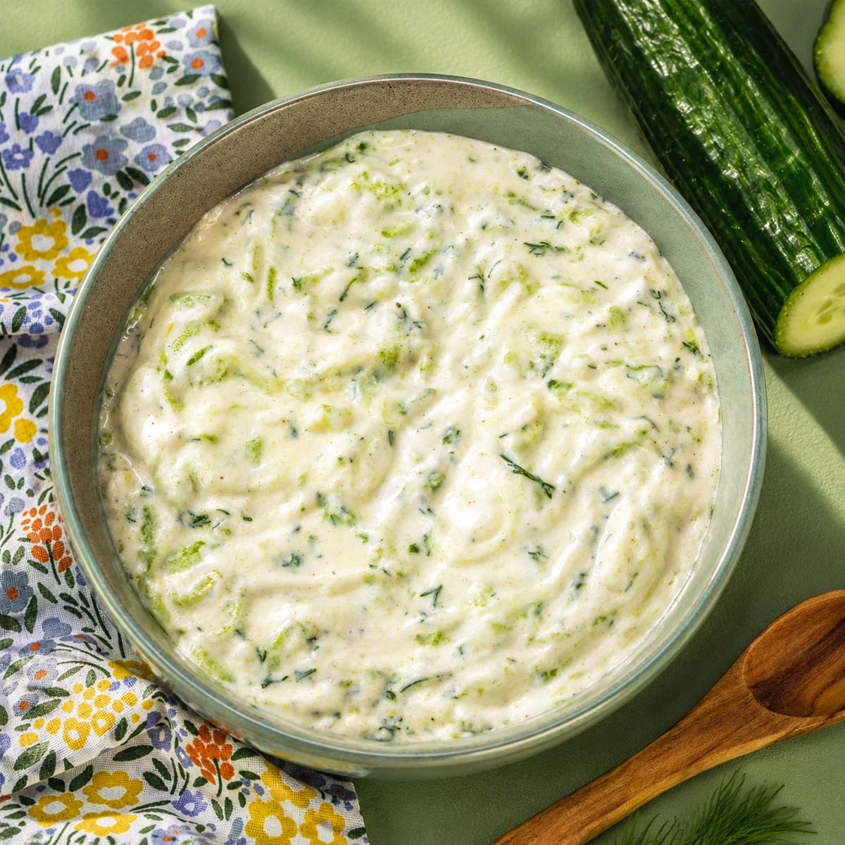 Overhead view of creamy homemade tzatziki sauce with cucumber and dill