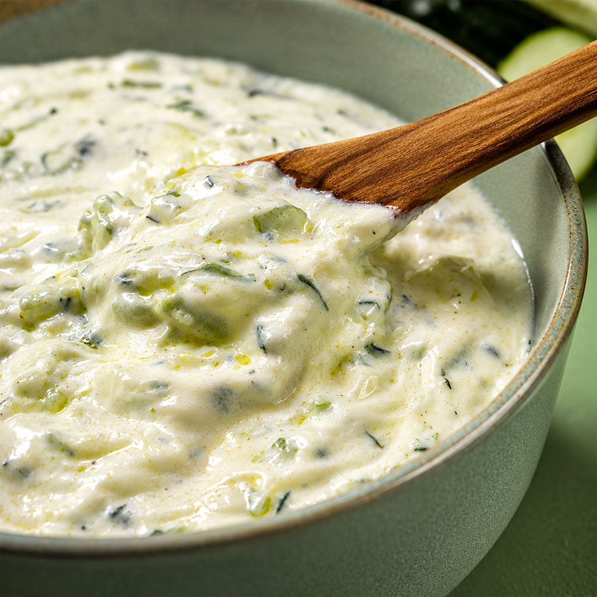 Close up of creamy homemade tzatziki sauce with cucumber and dill