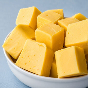 Bowl of lemon fudge squares made with sweetened condensed milk and white chocolate.