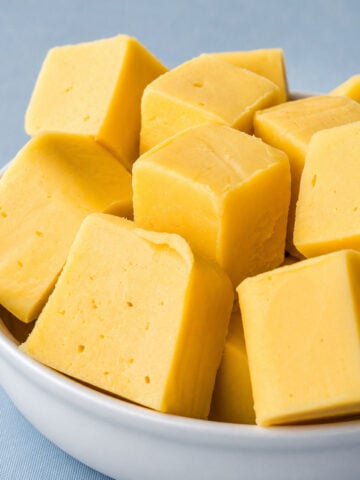 Bowl of lemon fudge squares made with sweetened condensed milk and white chocolate.