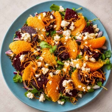 Lentil salad with orange dressing and feta topped with roasted beets, citrus segments, and fresh herbs