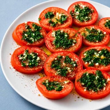 Marinated tomatoes topped with garlic, parsley, olive oil, and oregano
