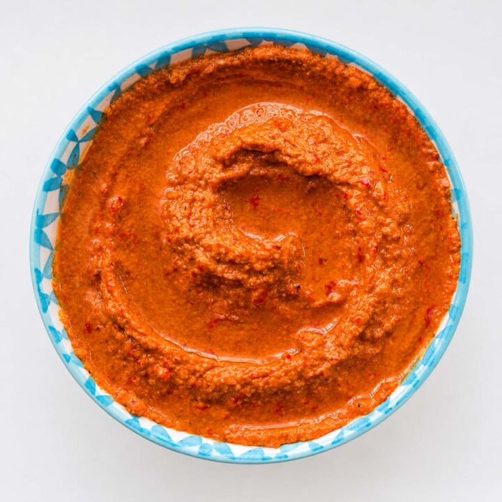 Easy muhammara dip recipe in a bowl with olive oil swirl and smooth texture