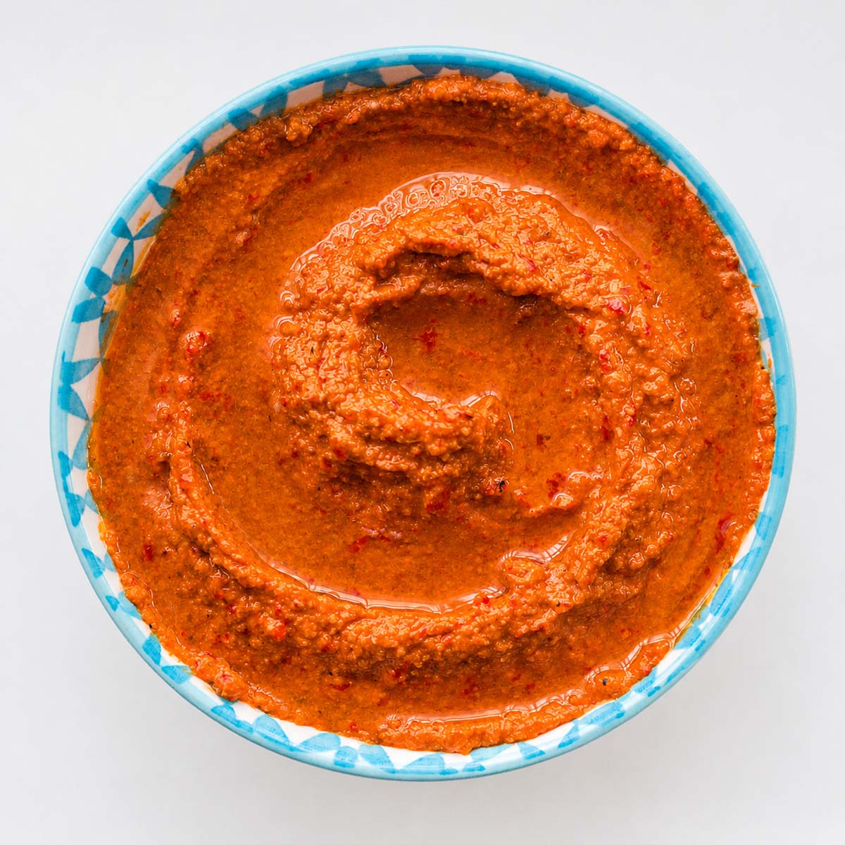 Easy muhammara recipe in a bowl with olive oil swirl and smooth texture