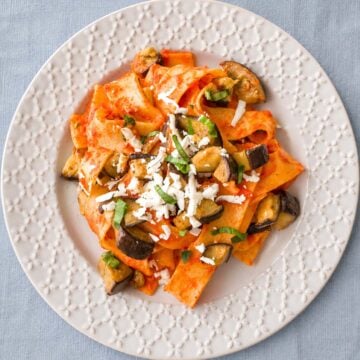 Pasta Alla Norma (Sicilian Eggplant Pasta) served with tomato sauce, fried eggplant, fresh basil, and grated ricotta salata