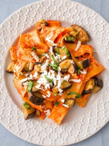 Pasta Alla Norma (Sicilian Eggplant Pasta) served with tomato sauce, fried eggplant, fresh basil, and grated ricotta salata
