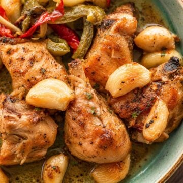 Spanish Garlic Chicken (Pollo al Ajillo) served with roasted garlic, peppers, and potatoes