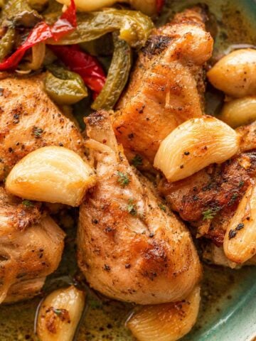 Spanish Garlic Chicken (Pollo al Ajillo) served with roasted garlic, peppers, and potatoes