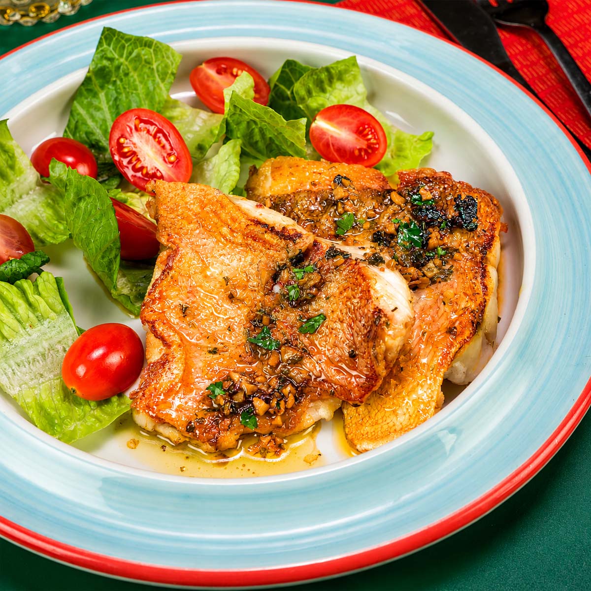Pan Seared Rock Fish with garlic herb butter sauce served with fresh lettuce and cherry tomatoes