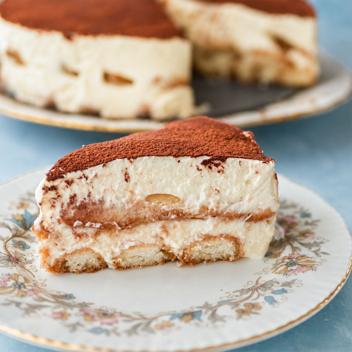 Easy tiramisu without raw eggs slice with cocoa topping and coffee-soaked ladyfingers