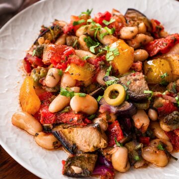close up White Bean Eggplant Caponata with roasted eggplant, white beans, peppers, olives, and fresh parsley