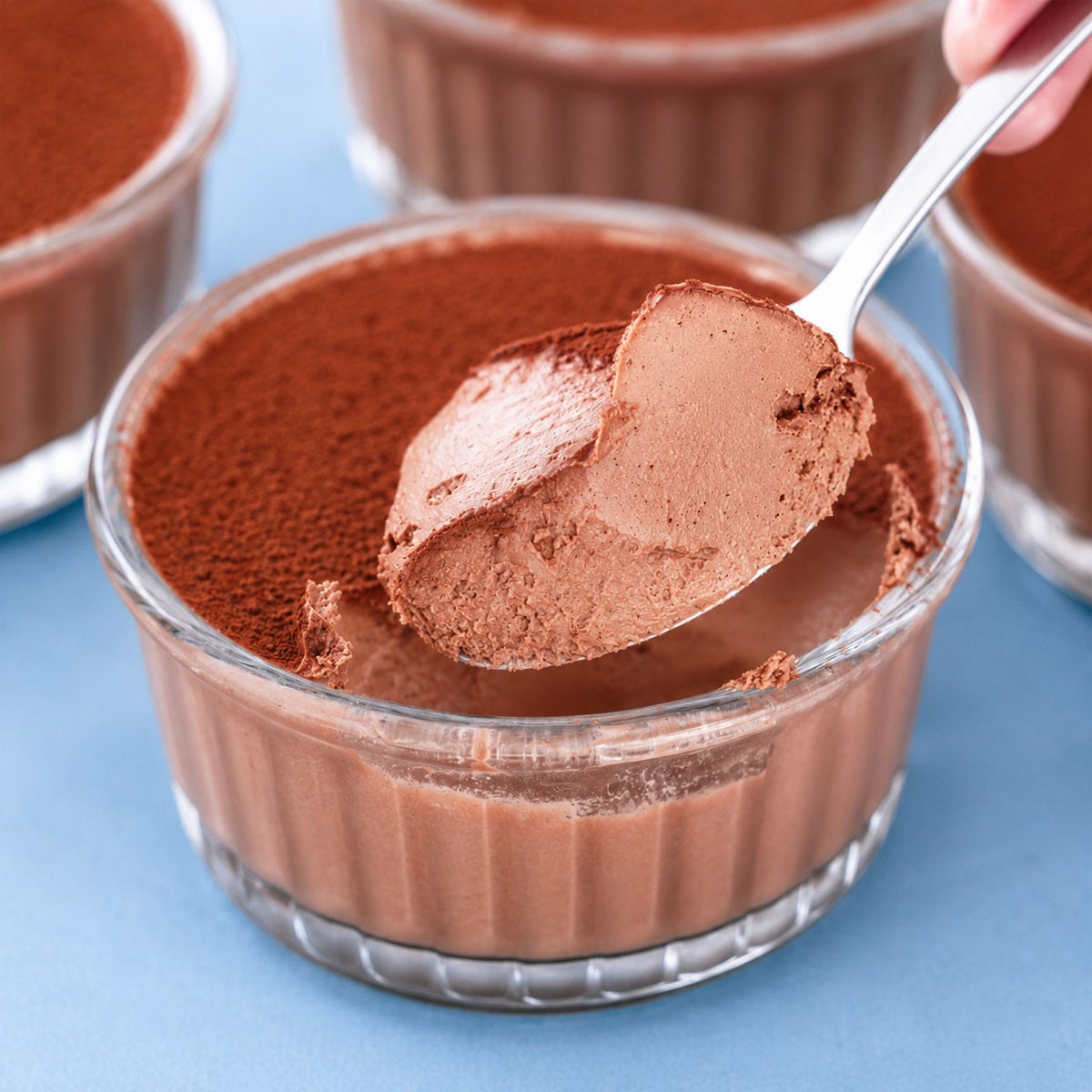 2 Ingredient Chocolate Dessert served in glass ramekins with a creamy chocolate mousse texture and cocoa powder topping
