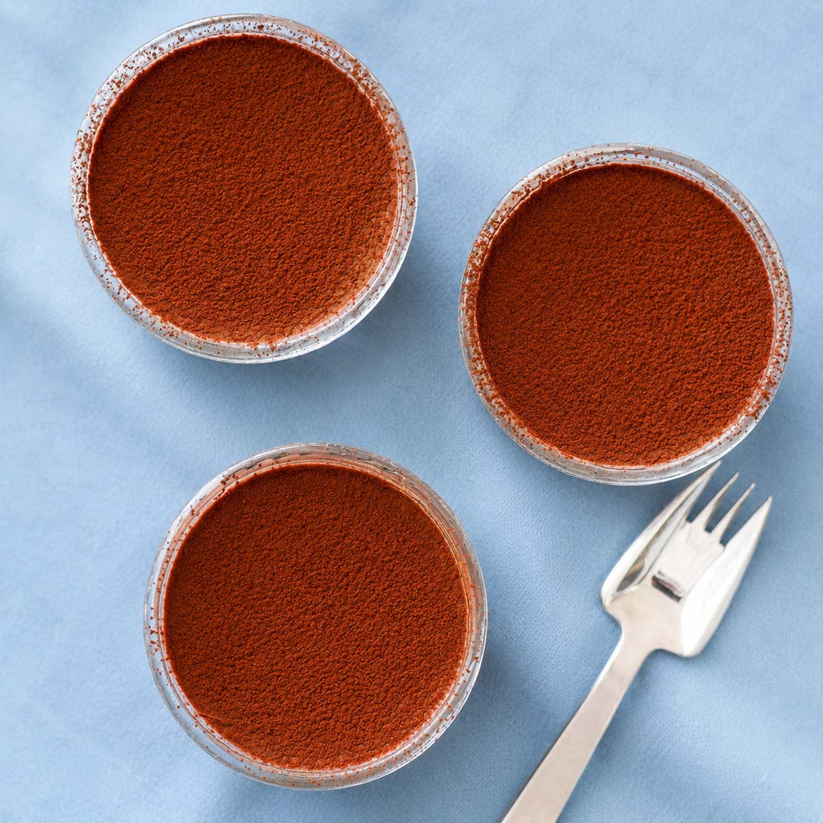 2 Ingredient Chocolate Dessert in glass ramekins topped with cocoa powder
