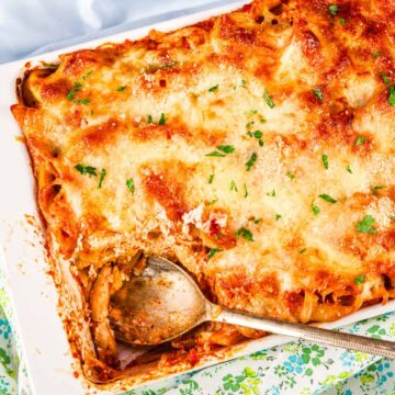 Baked Ziti with Ricotta and Mozzarella baked in a casserole dish with golden melted cheese and marinara sauce