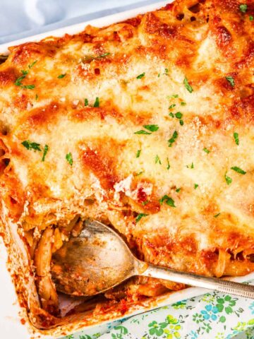 Baked Ziti with Ricotta and Mozzarella baked in a casserole dish with golden melted cheese and marinara sauce