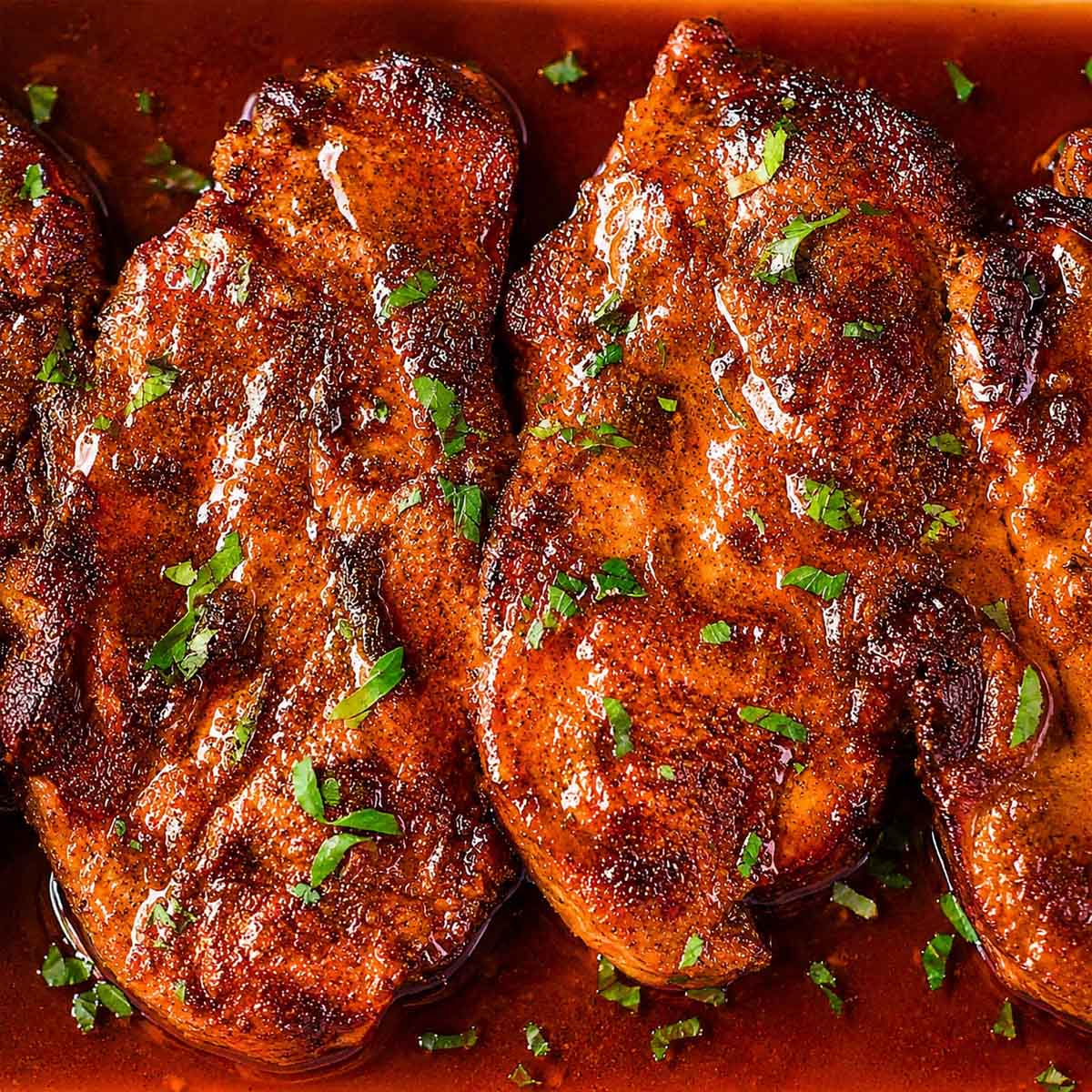 Baked pork steaks in a rich paprika sauce, oven cooked until tender and finished with fresh parsley.