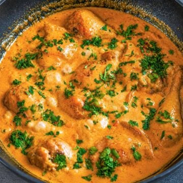 Creamy balsamic chicken in a rich skillet sauce garnished with fresh parsley.