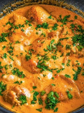 Creamy balsamic chicken in a rich skillet sauce garnished with fresh parsley.