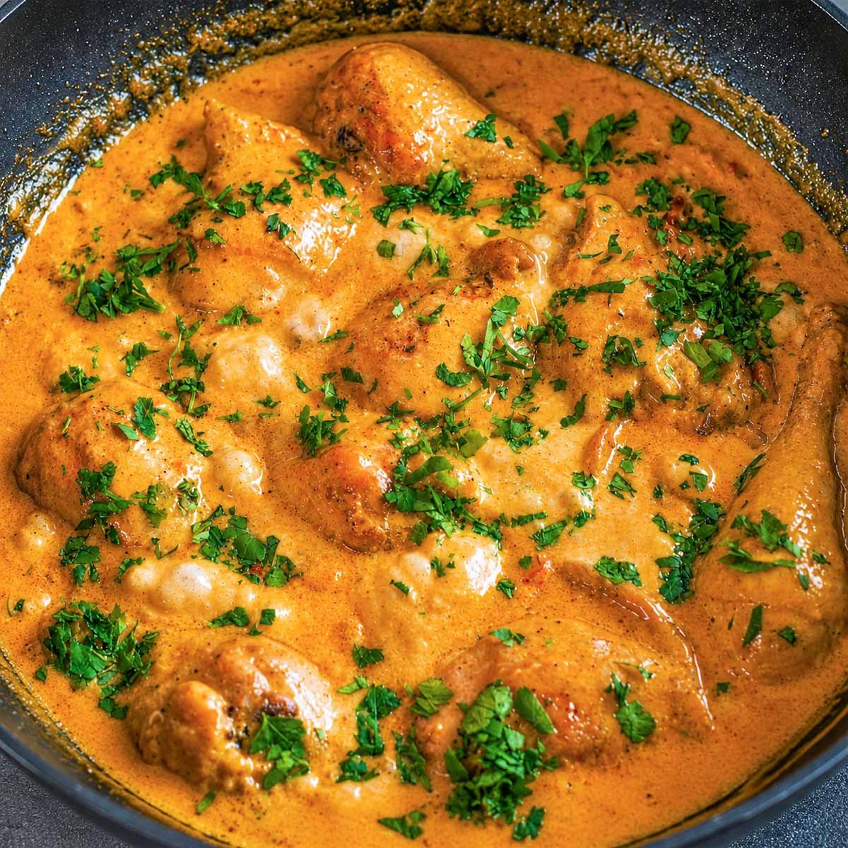 Creamy balsamic chicken in a rich skillet sauce garnished with fresh parsley.