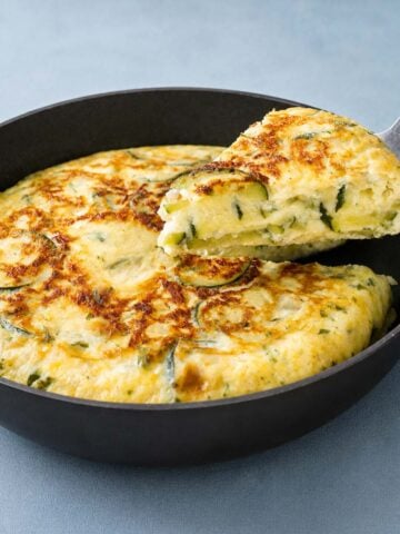 Zucchini Frittata in Skillet with Golden Cheese Crust and Creamy Zucchini Filling