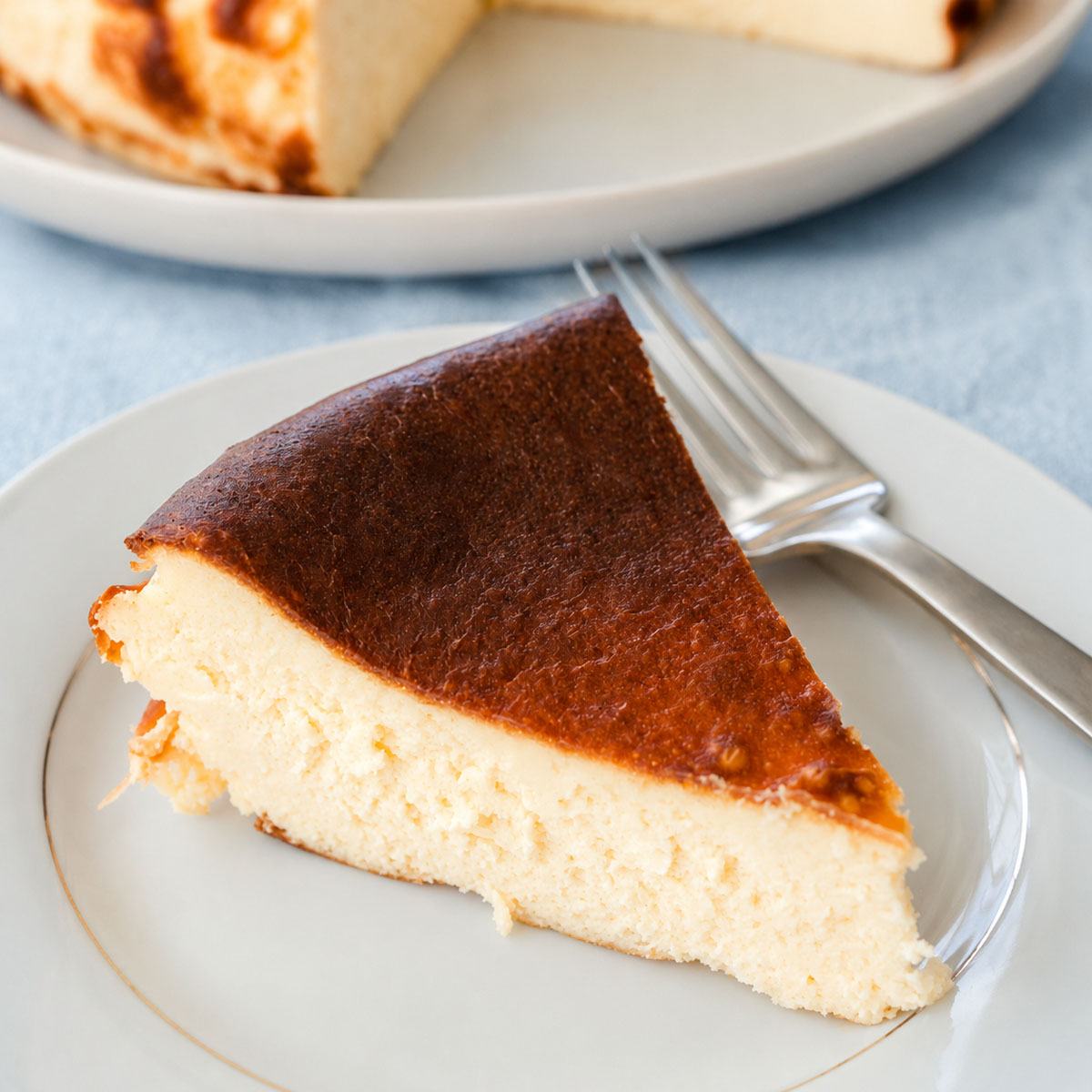 Basque burnt cheesecake slice with creamy texture and caramelized top