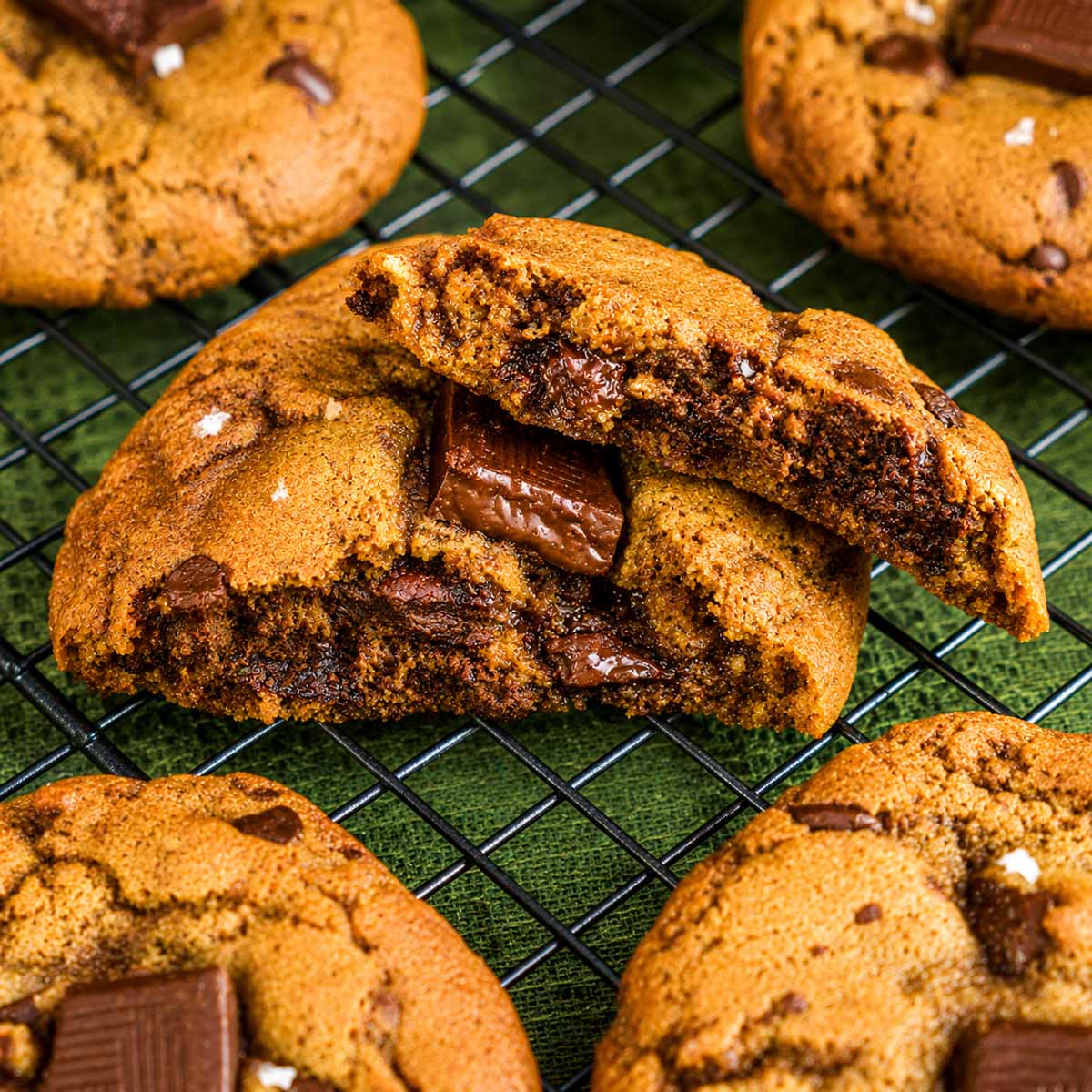 Chewy brown butter chocolate chip cookie broken open to show its soft center and melted chocolate.