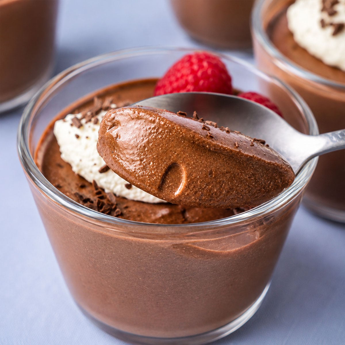 Spoon scooping smooth cottage cheese chocolate mousse to show its rich, creamy texture