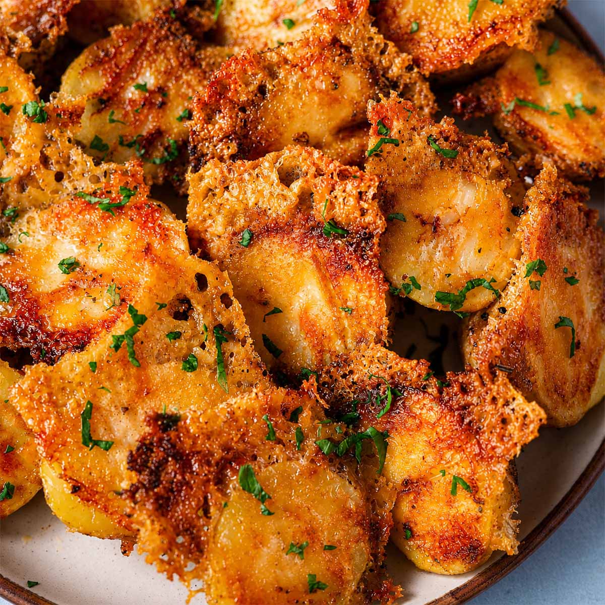 Close-up of Crispy Parmesan Potatoes with Golden Cheese Crust showing crunchy Parmesan coating and tender roasted baby potatoes
