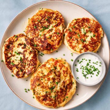 Crispy leftover mashed potato pancake ingredients mixed in a bowl with cheese, chives, egg, and seasonings